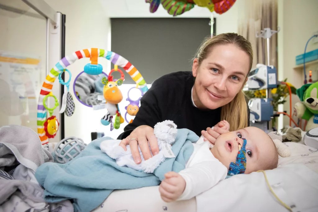 Brave Baby Jax and Mum pictures at the RCH Melbourne, surrounded by bright colourful baby toys