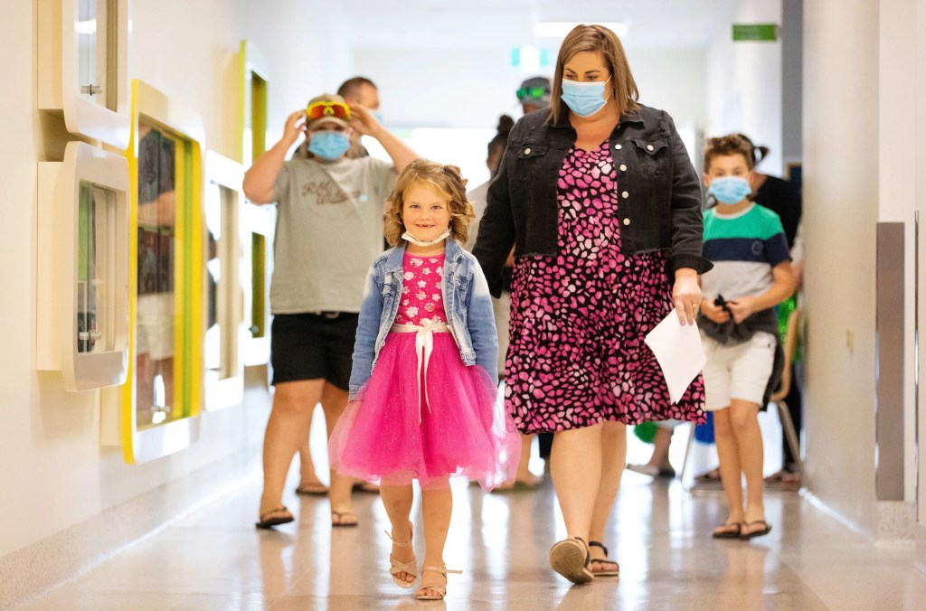 Ivy walking proudly out of the hospital after she rang the bell